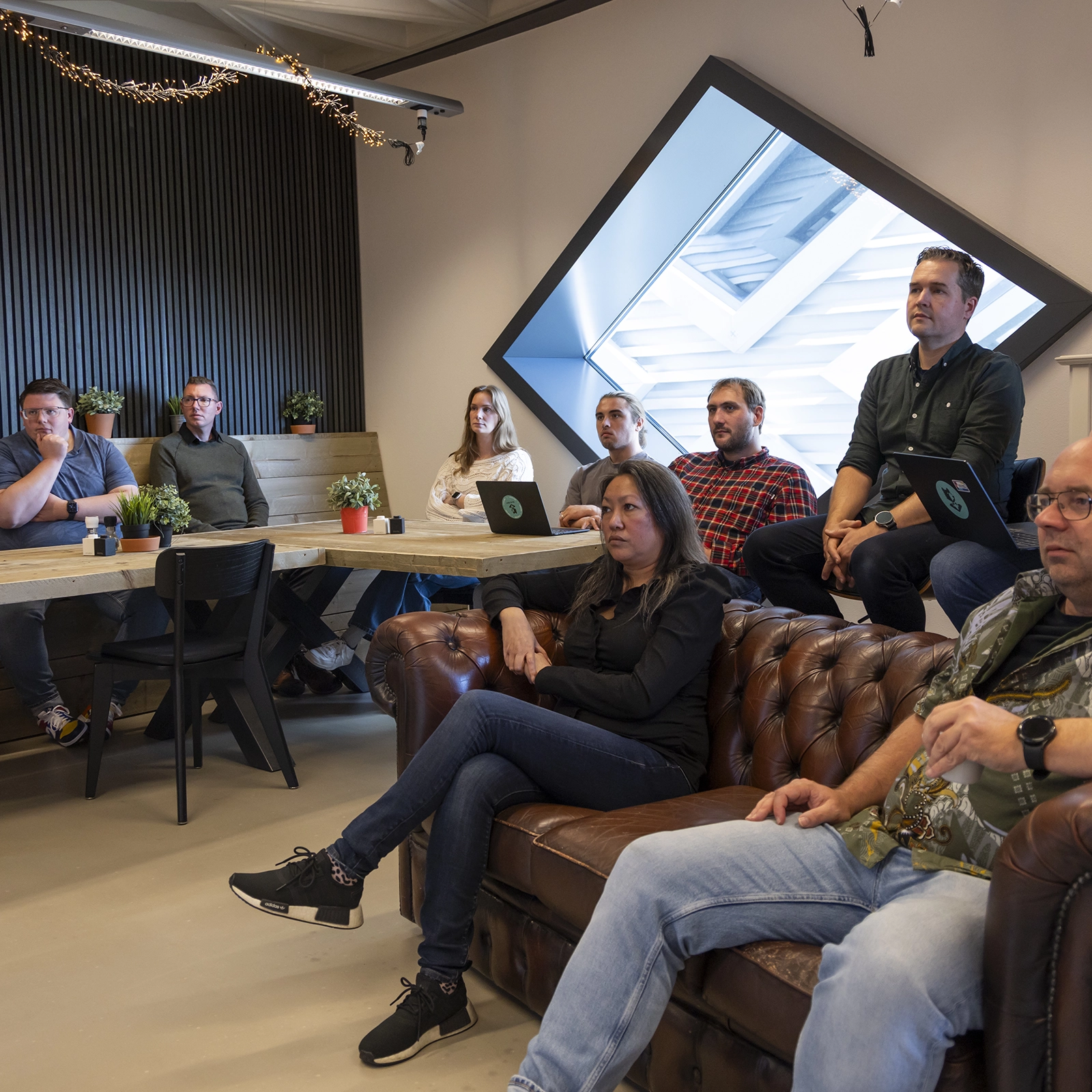 Een designer maakt een wireframe schets op een flip-over tijdens een meeting.